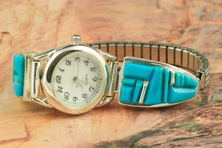 Genuine Sleeping Beauty Turquoise set in Sterling Silver. Beautiful handcarved Turquoise Stones set between ribbons of Sterling Silver. Stunning Ladies Watch. Designed by Navajo Artist Calvin Begay. Signed.
